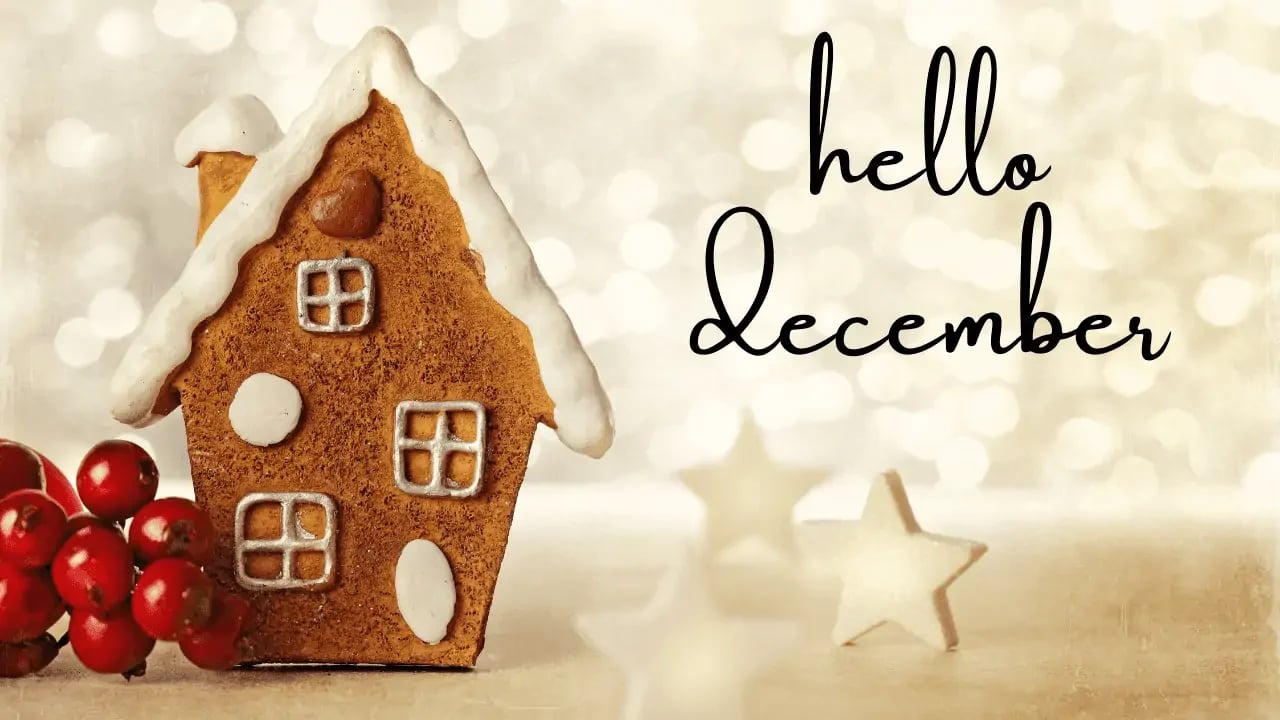A festive gingerbread house with the words "hello December" written beside it. The image evokes holiday cheer and the start of the winter season.
