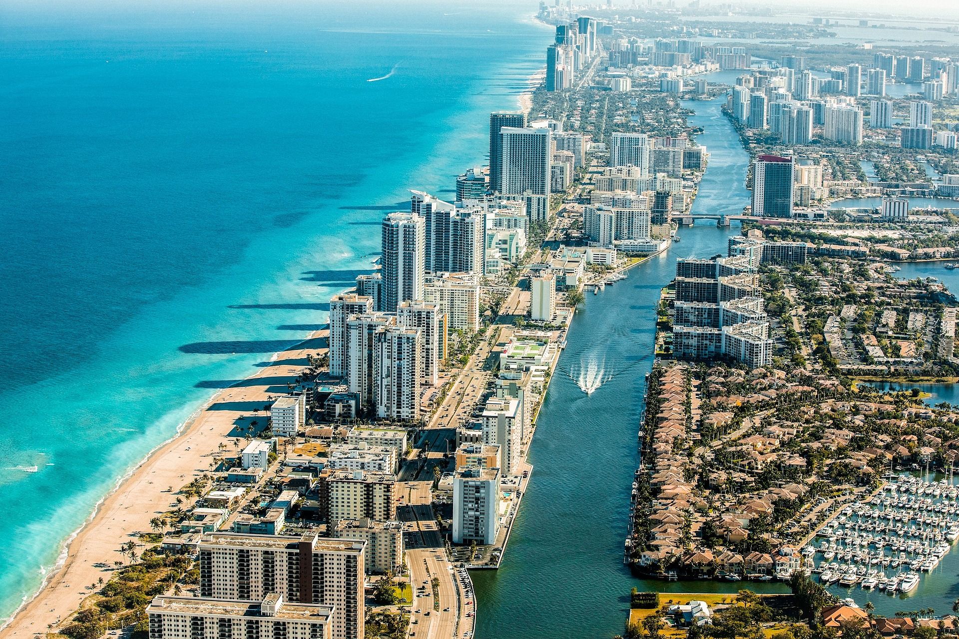 Aerial view of Miami Beach’s shoreline, high-rises, and Intracoastal Waterway.
