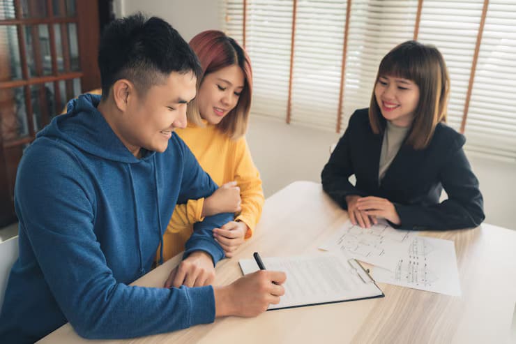 happy young asian couple with notary signing agent