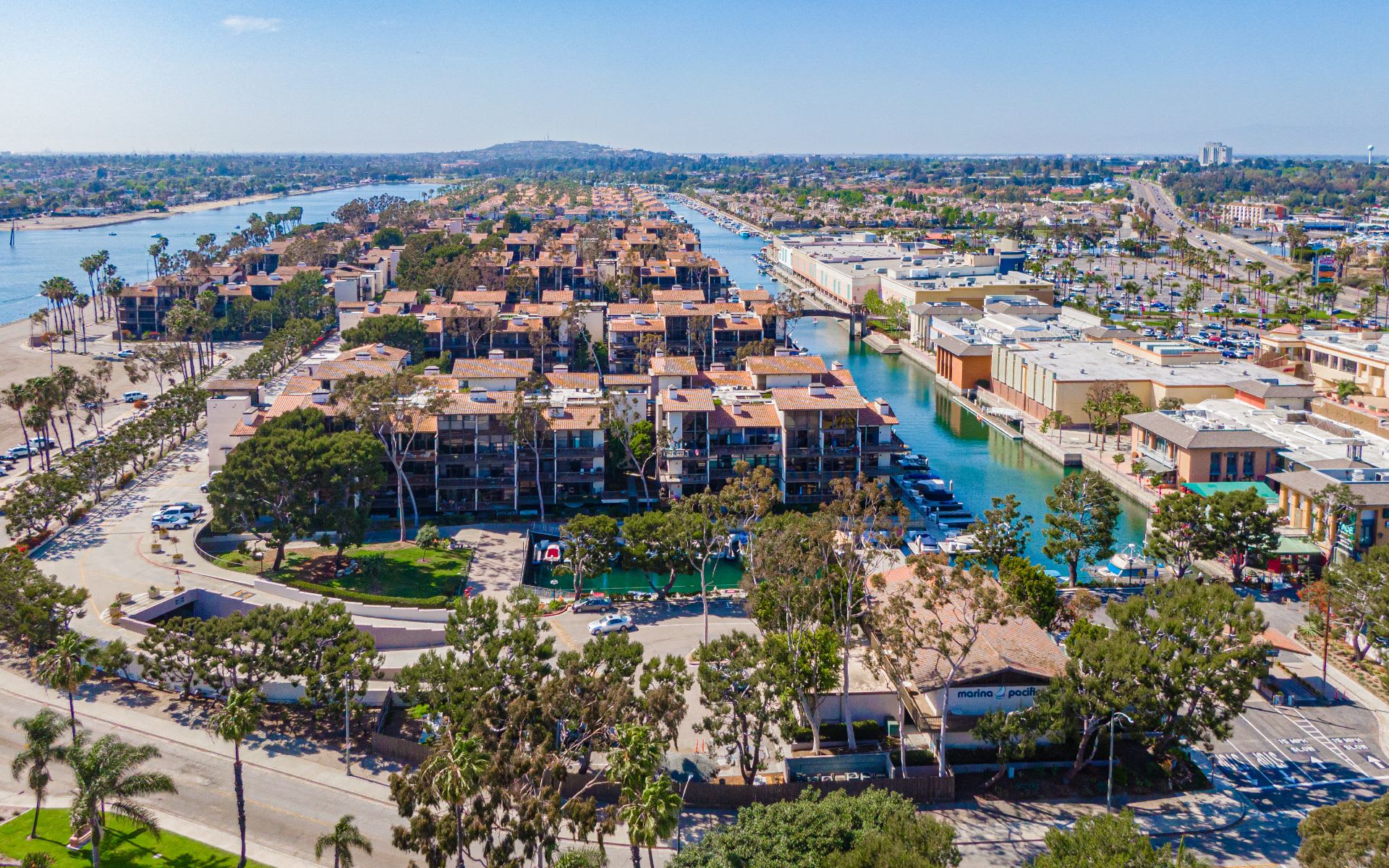 Aerial view of waterfront condominiums and canals at Marina Pacifica.