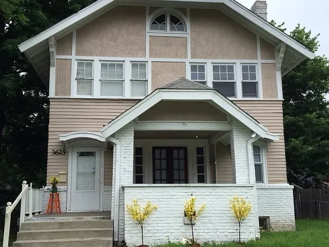 Two-story house with a steep gabled roof and covered front porch at 3625 Coliseum Ave.