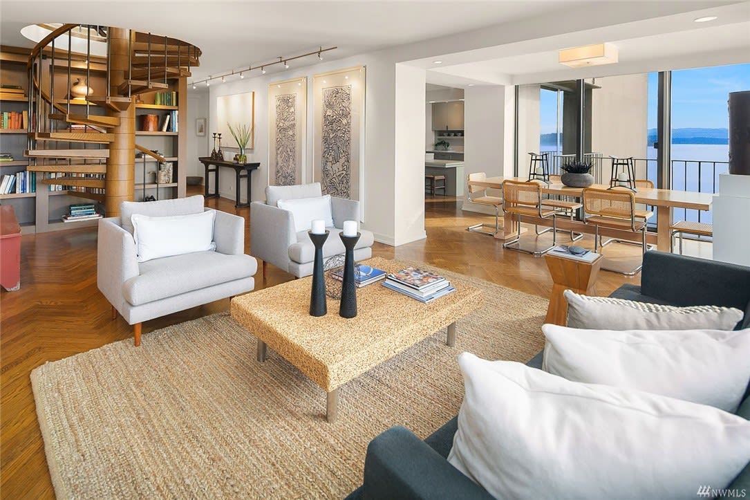 Luxurious, bright condo with open-plan living, warm wooden floors, and ocean views showcasing an inviting atmosphere.