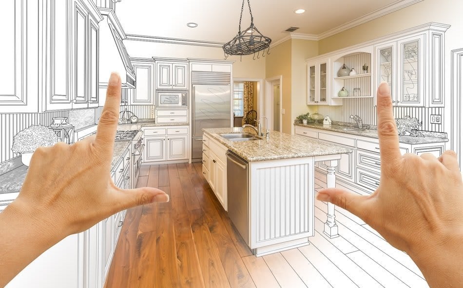 Kitchen renovation concept with hands framing a blend of architectural sketch and finished interior.