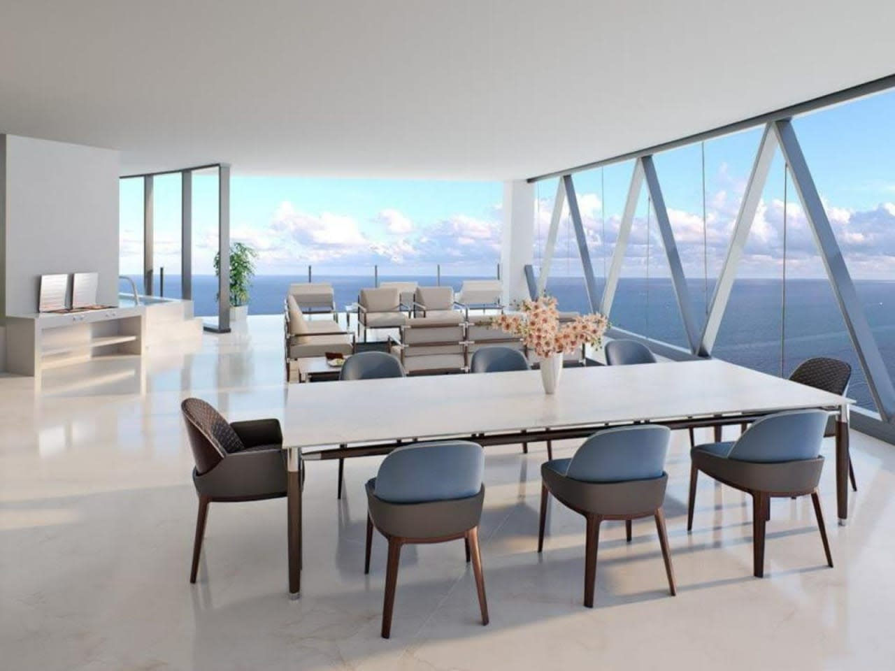 Modern dining area with floor-to-ceiling windows overlooking the ocean.
