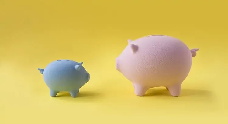 Two piggy banks, one blue and one pink, set against a yellow background. This image likely symbolizes saving money or financial planning.