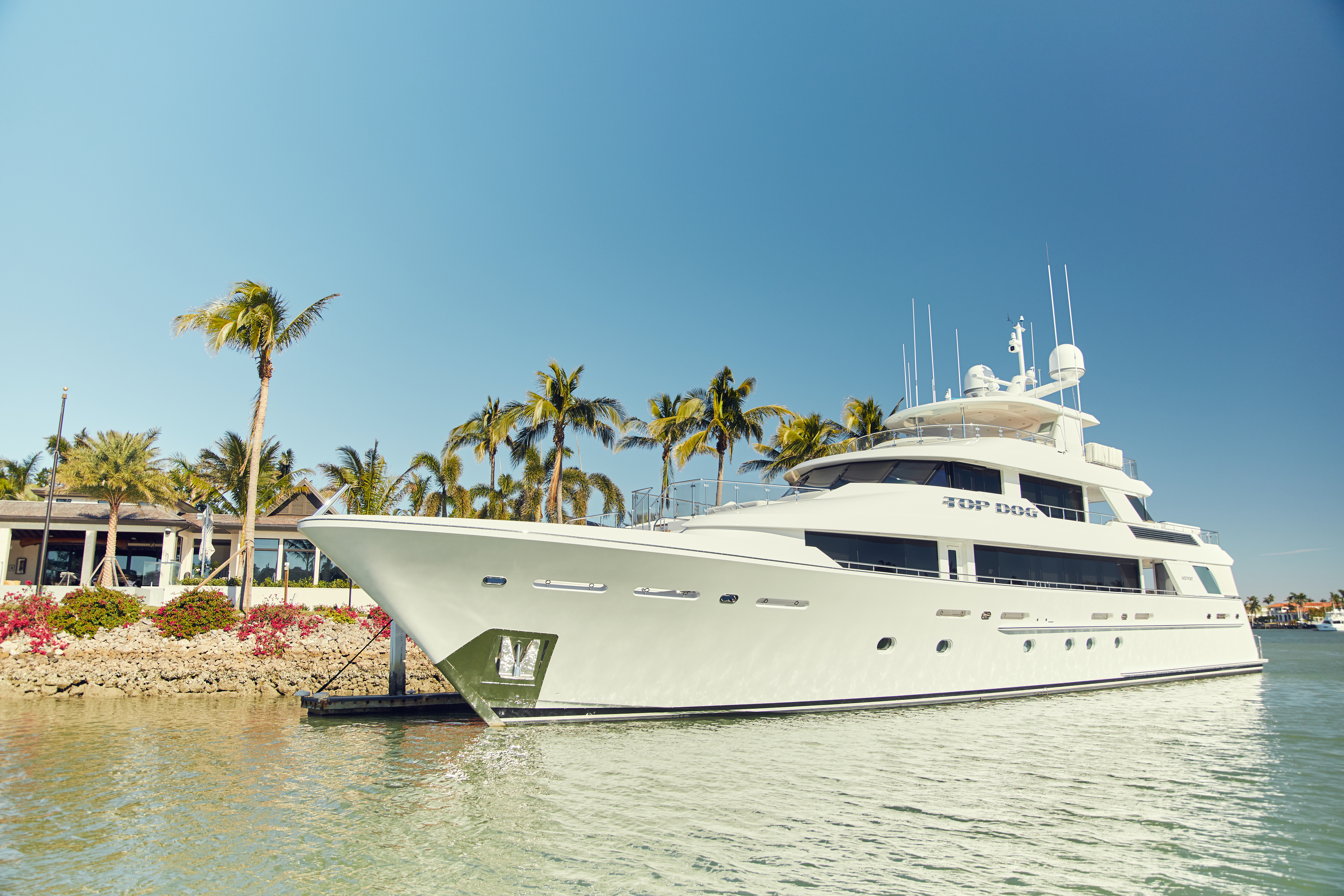 A yacht at a private Port Royal dock in front of a waterfront estate