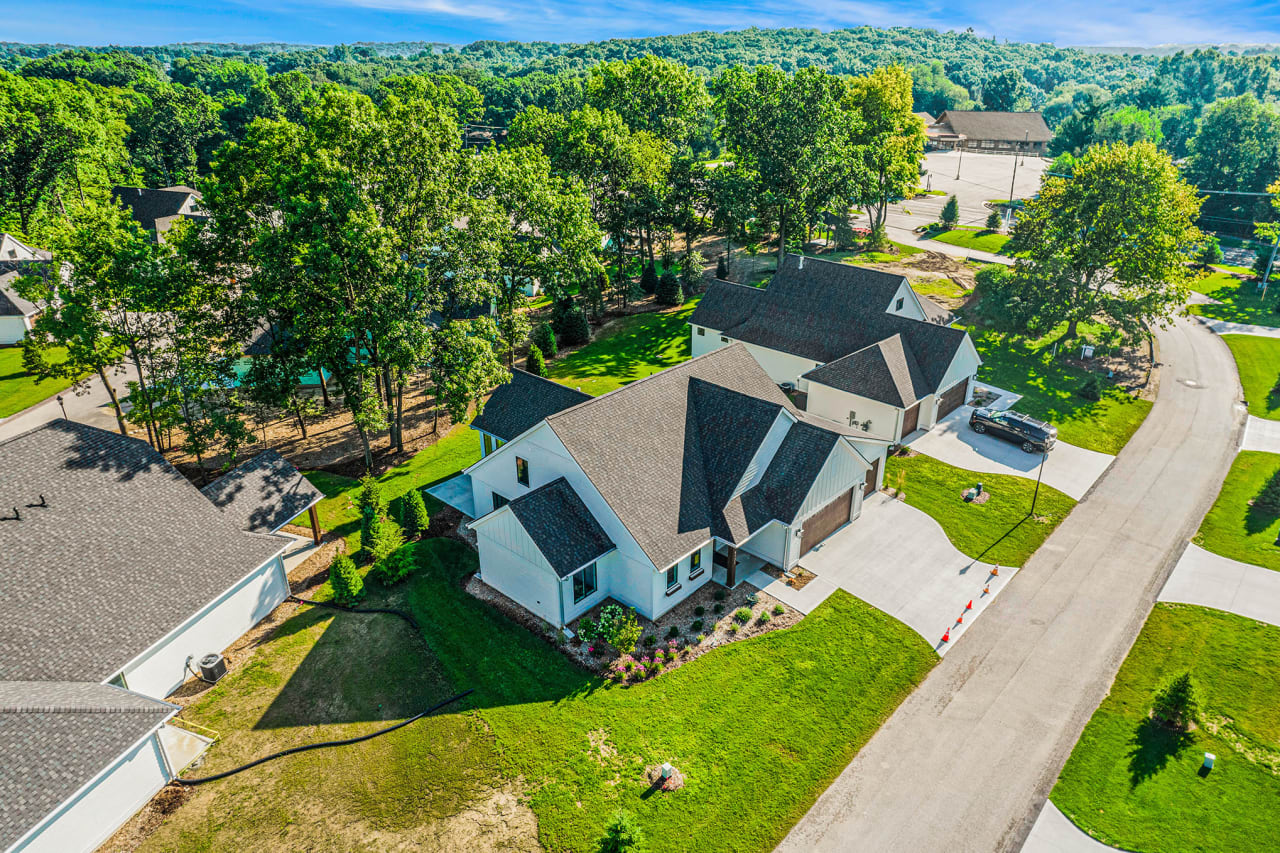 aerial photo of single family house with driveway and lawn