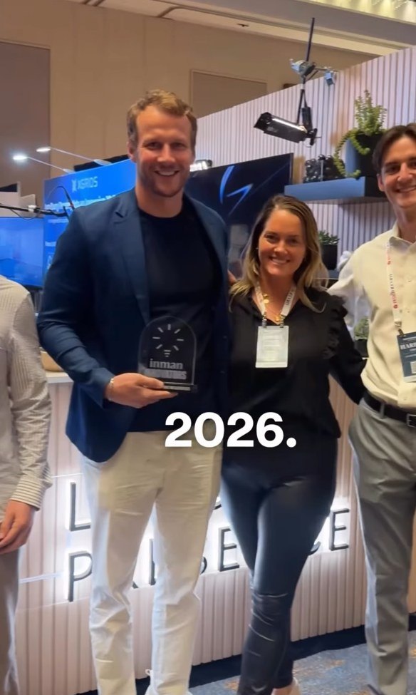 Malte Kramer, Founder and CEO of Luxury Presence, holding the Inman Innovator Award onstage at Inman Connect San Diego