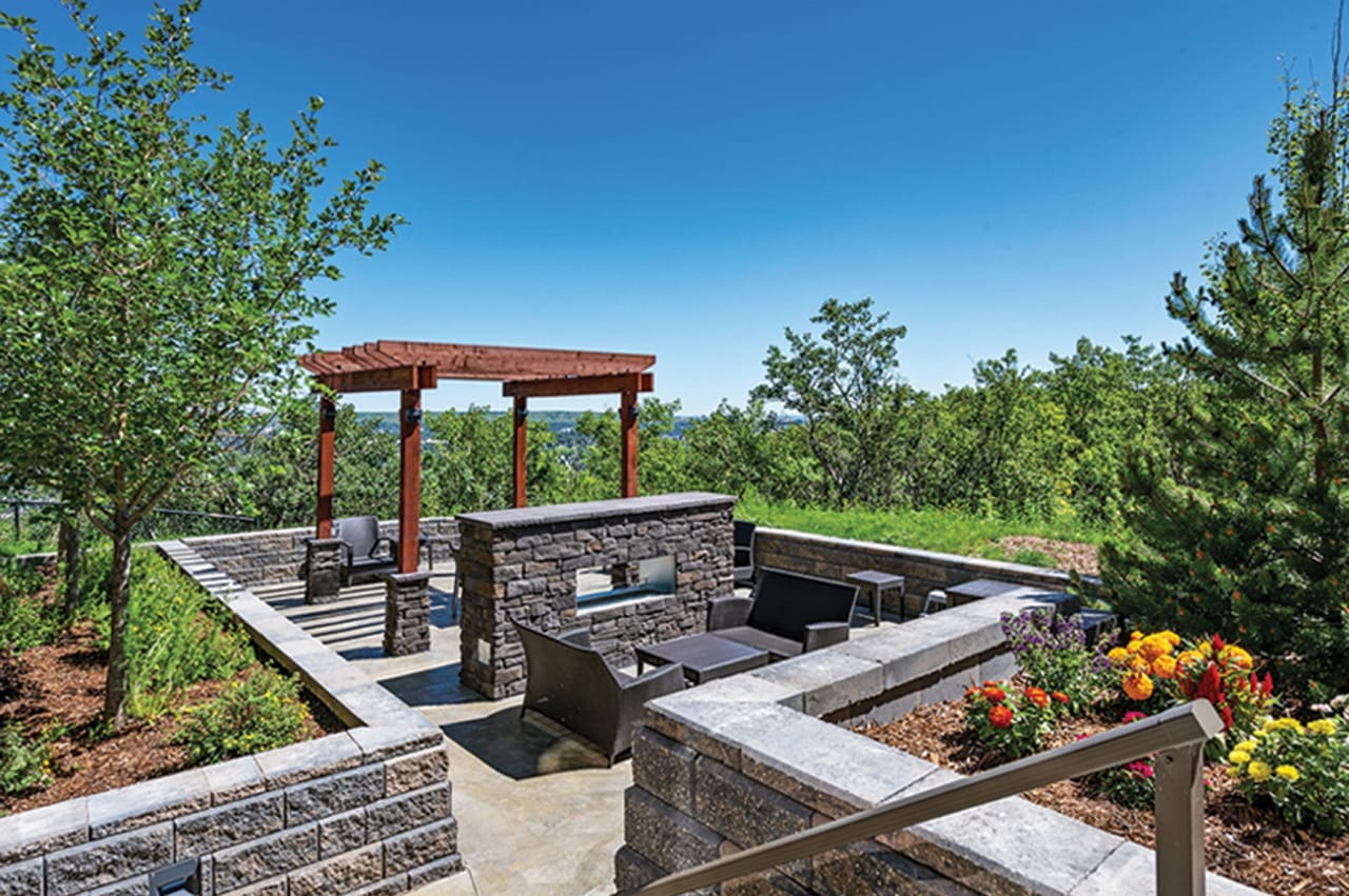 A cozy patio with a fire pit and a pergola