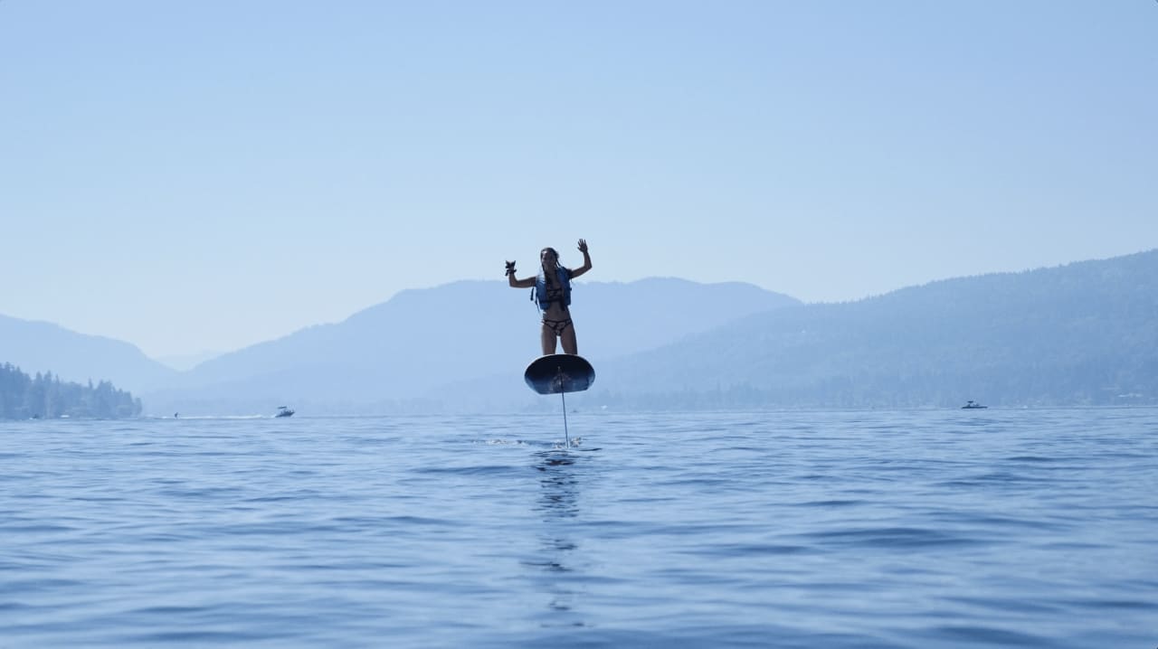 a lady enjoying a watersport in a sunny day