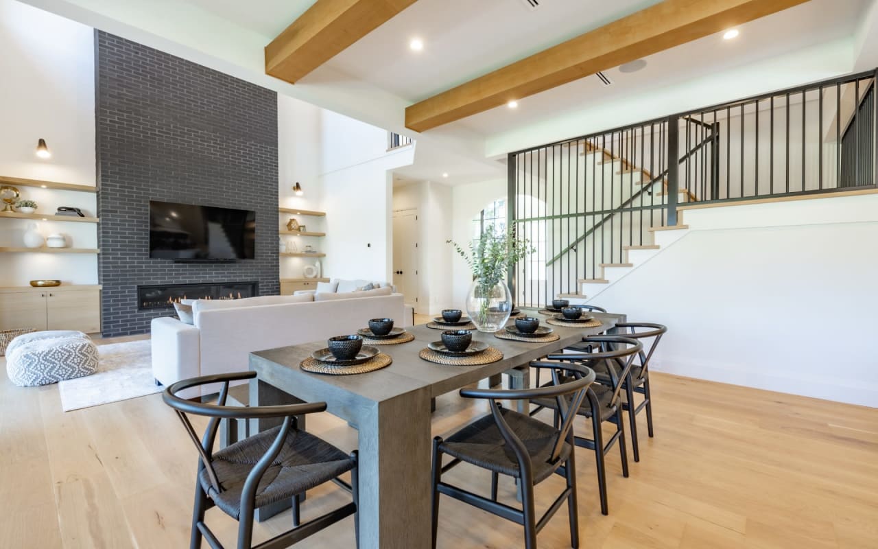 A dining table and chairs in a living room.