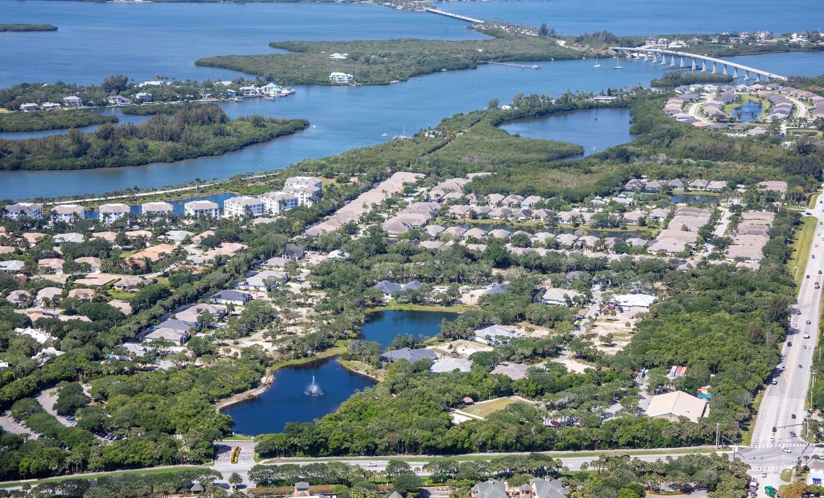 Aerial view of the barrier island community near Vero Beach, Florida, showing the Indian River Lagoon, a bridge, and residential neighborhoods