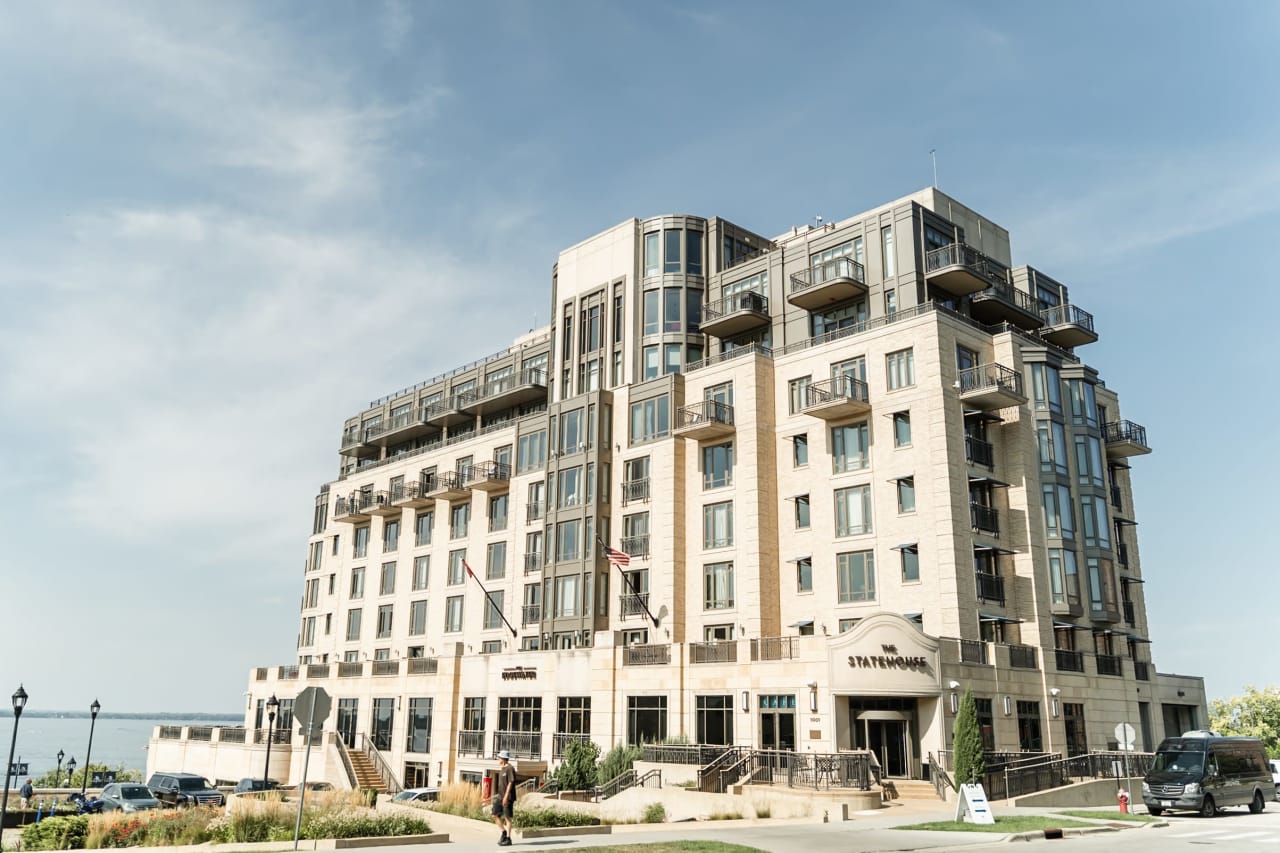 A large, modern building with a flat roof and a glass facade.