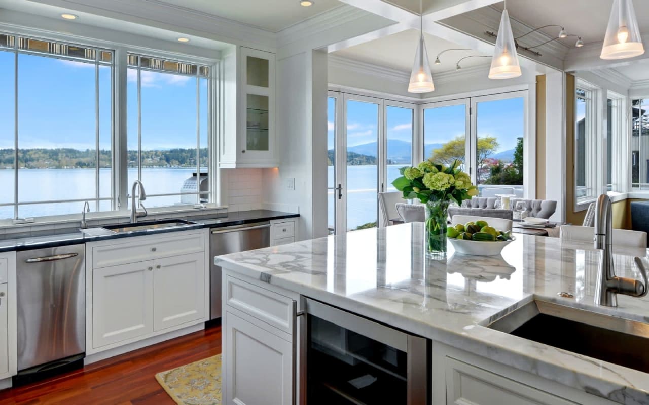 Kitchen with island, sink, bar-height counter, stove, refrigerator, and dishwasher