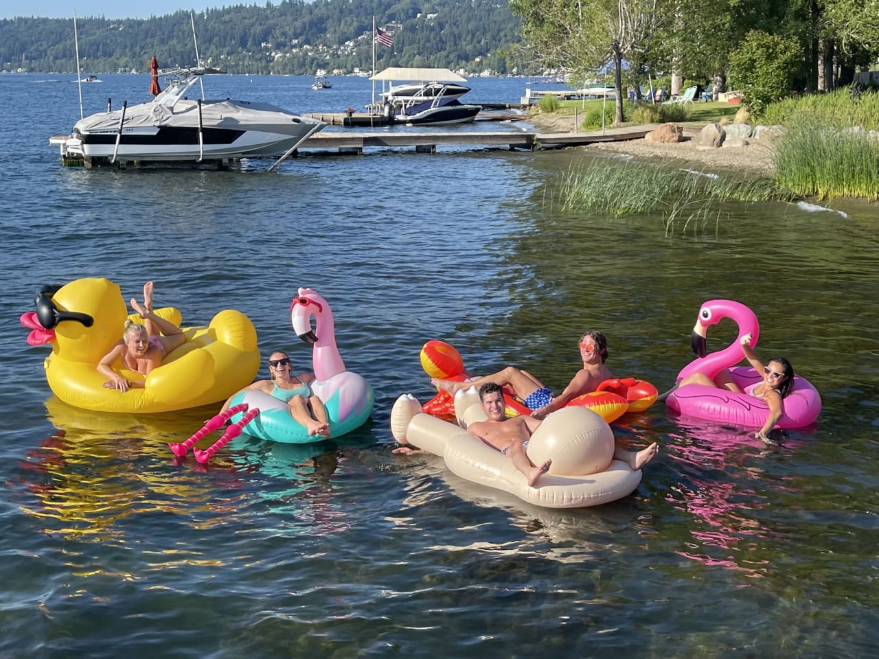 a bunch of people riding on a duck and swan inflatables