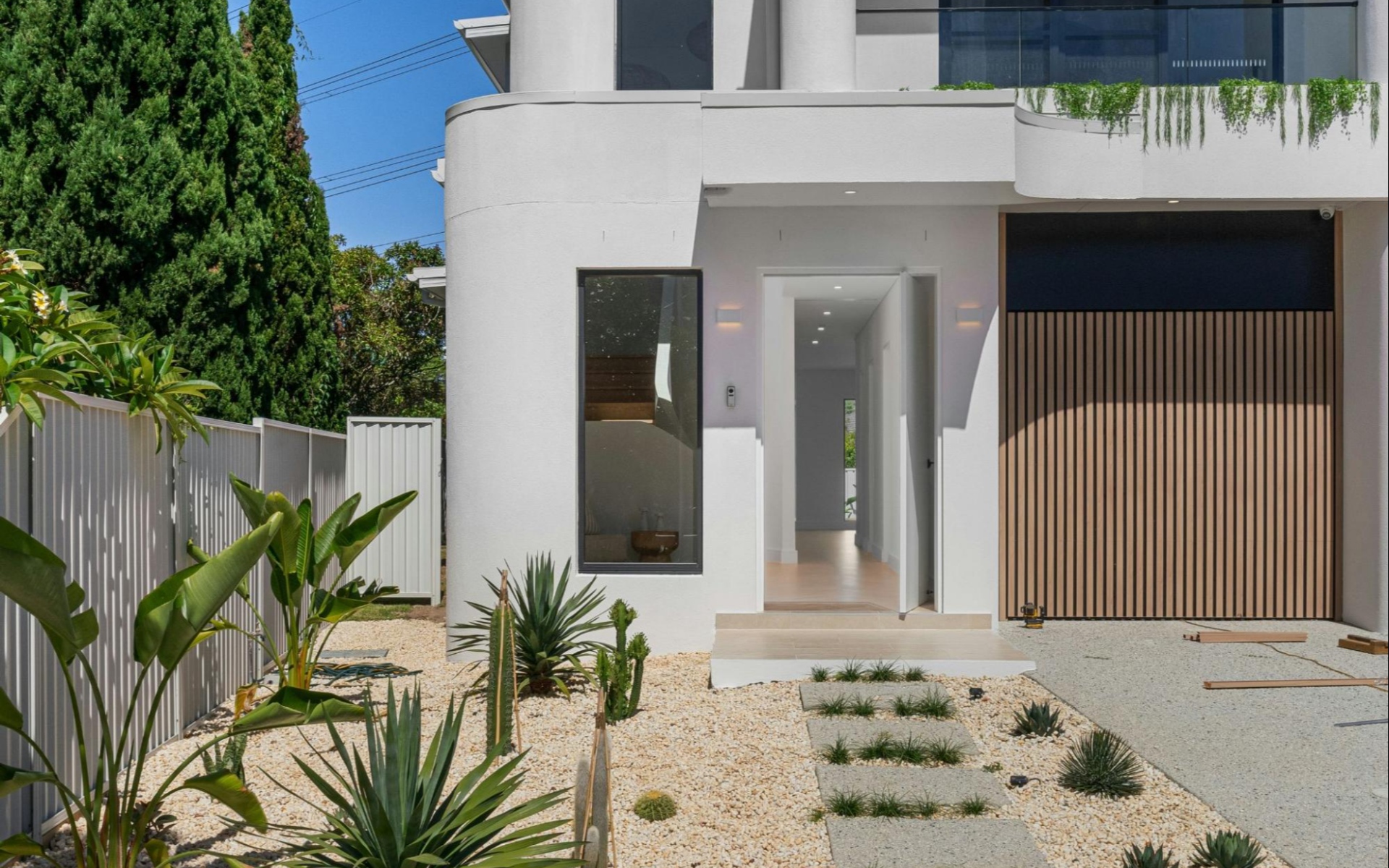 Modern Home Exterior with Succulent Garden and Sleek Real Estate Design