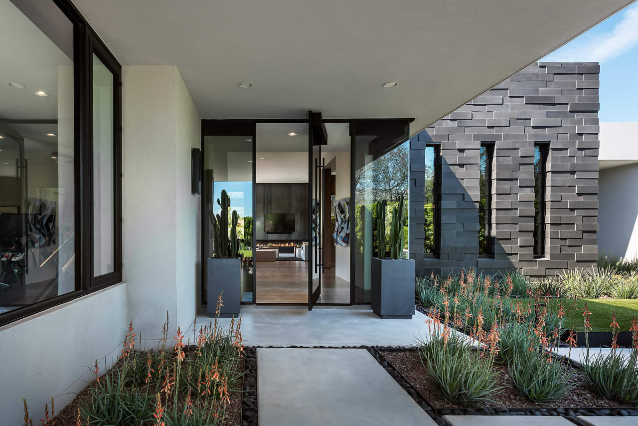 Entry to modern home with glass and stone