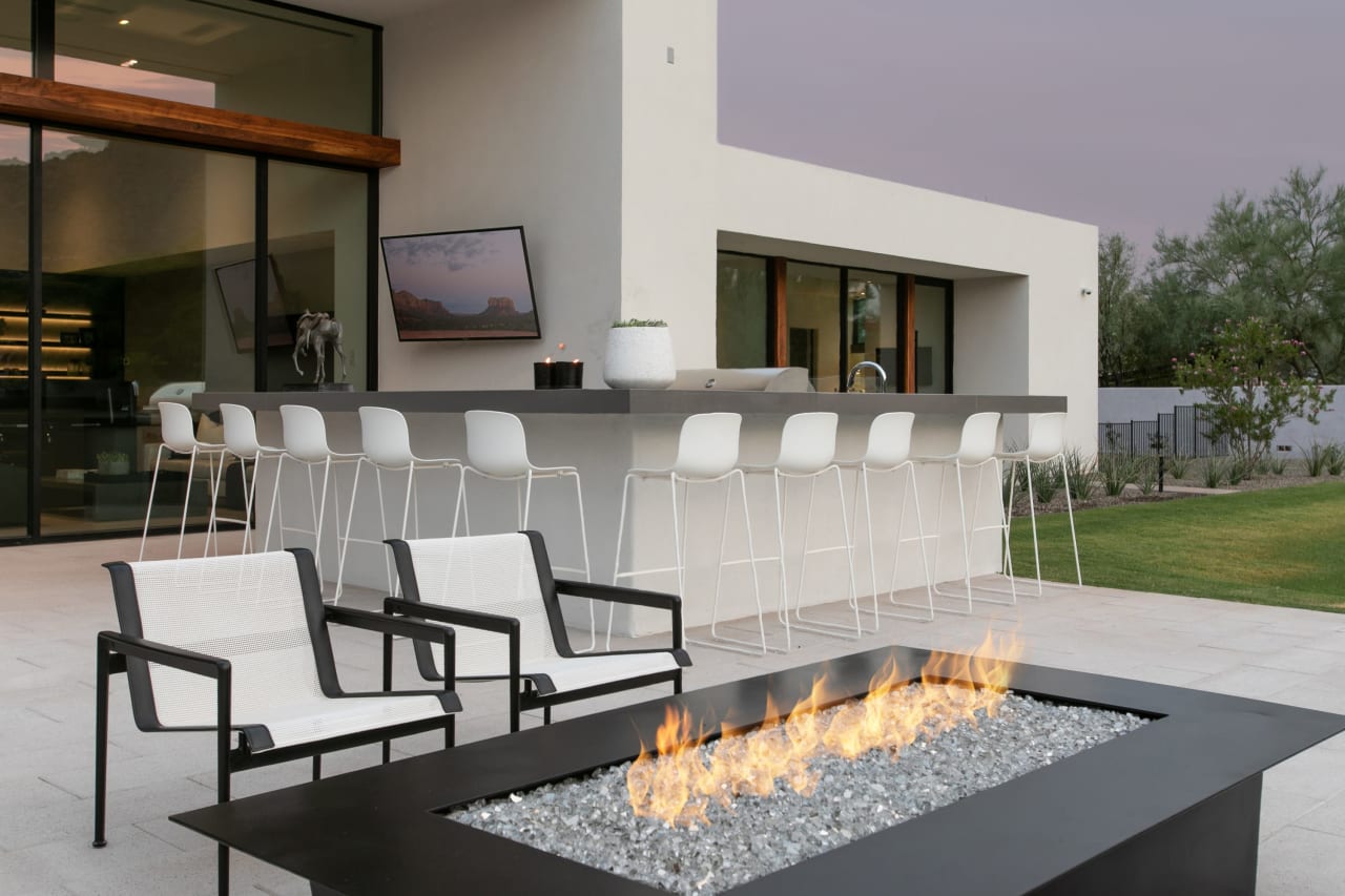 Modern firepit and bar at luxury home outdoor living 