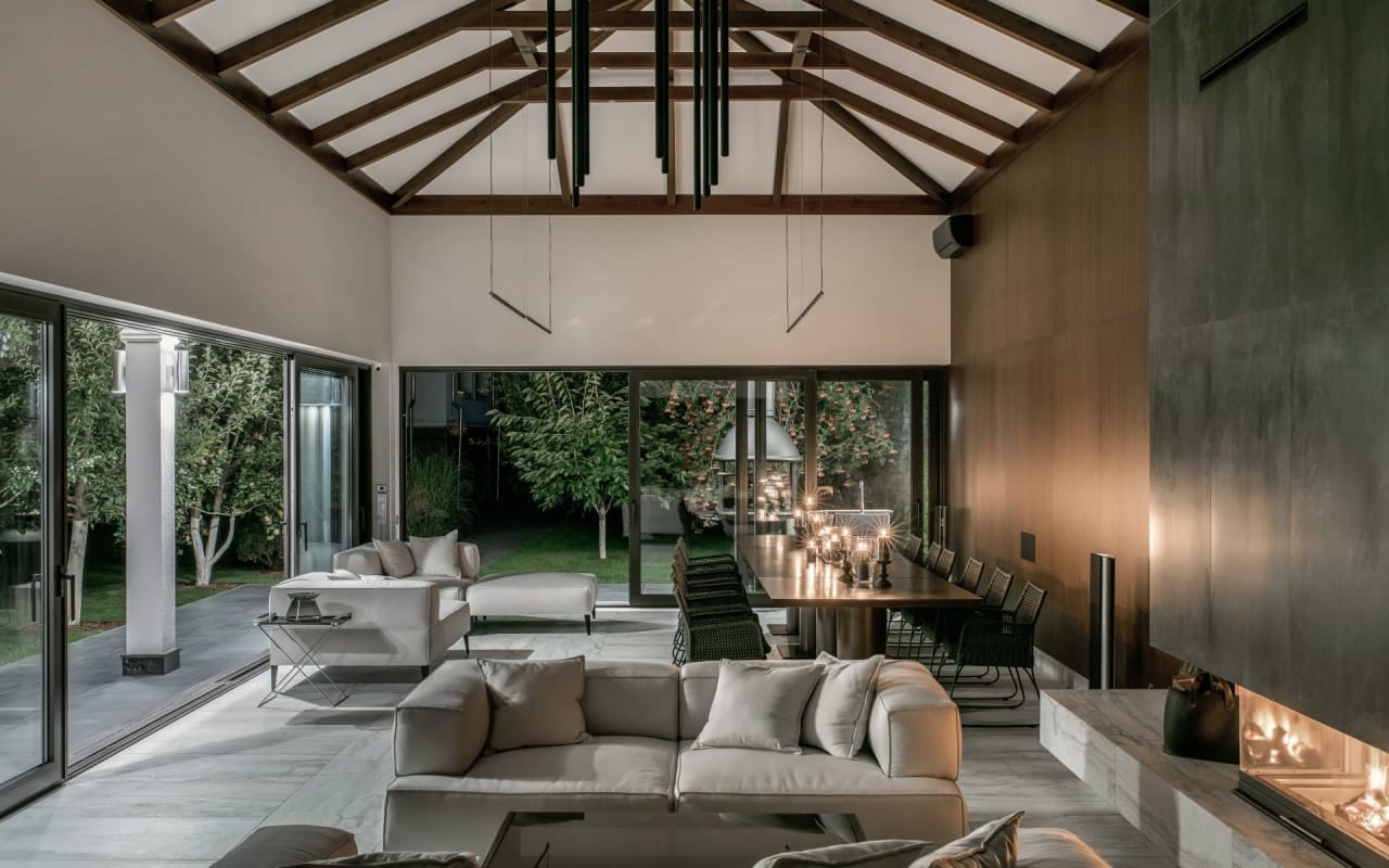  A living room with a fireplace, a couch, and a table.