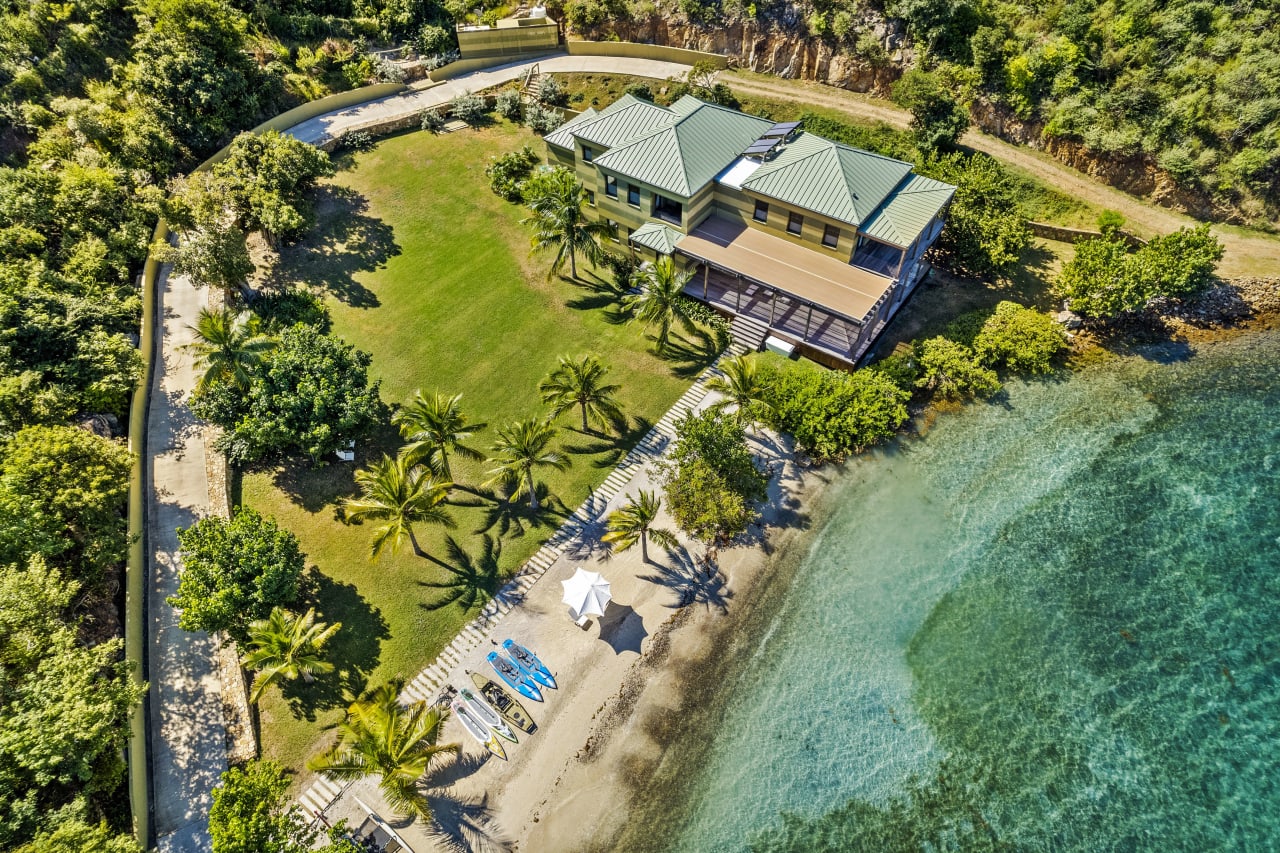 An aerial view of a house and a beach