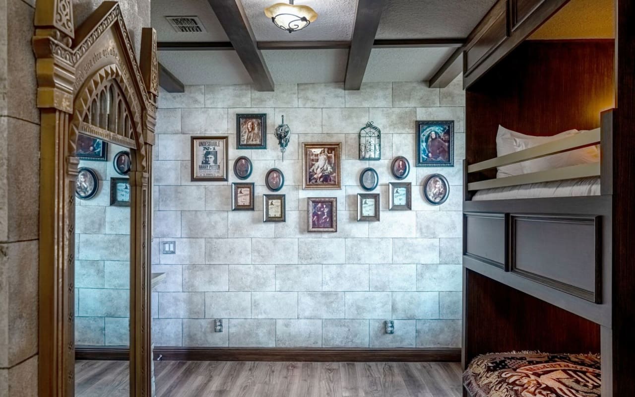 A cozy bedroom with bunk beds in a wooden frame, and nightstands lamps on either side of the lower bunk