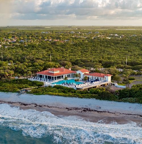 Vero Beach barrier island — private beach clubs, gated estates, pristine coastline