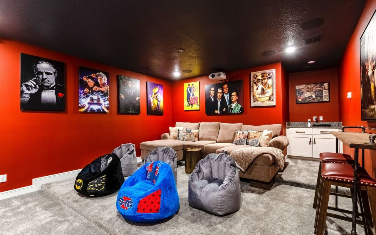 A living room with a comfortable couch in the center and beanbag chairs