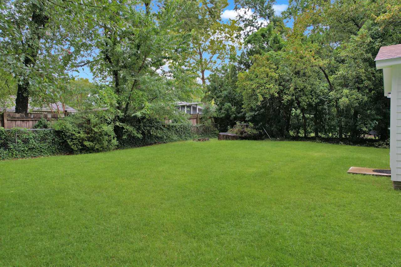 Photo of the fenced backyard featuring green grass at 1228 Winifred Drive, Tallahassee, Florida 32308