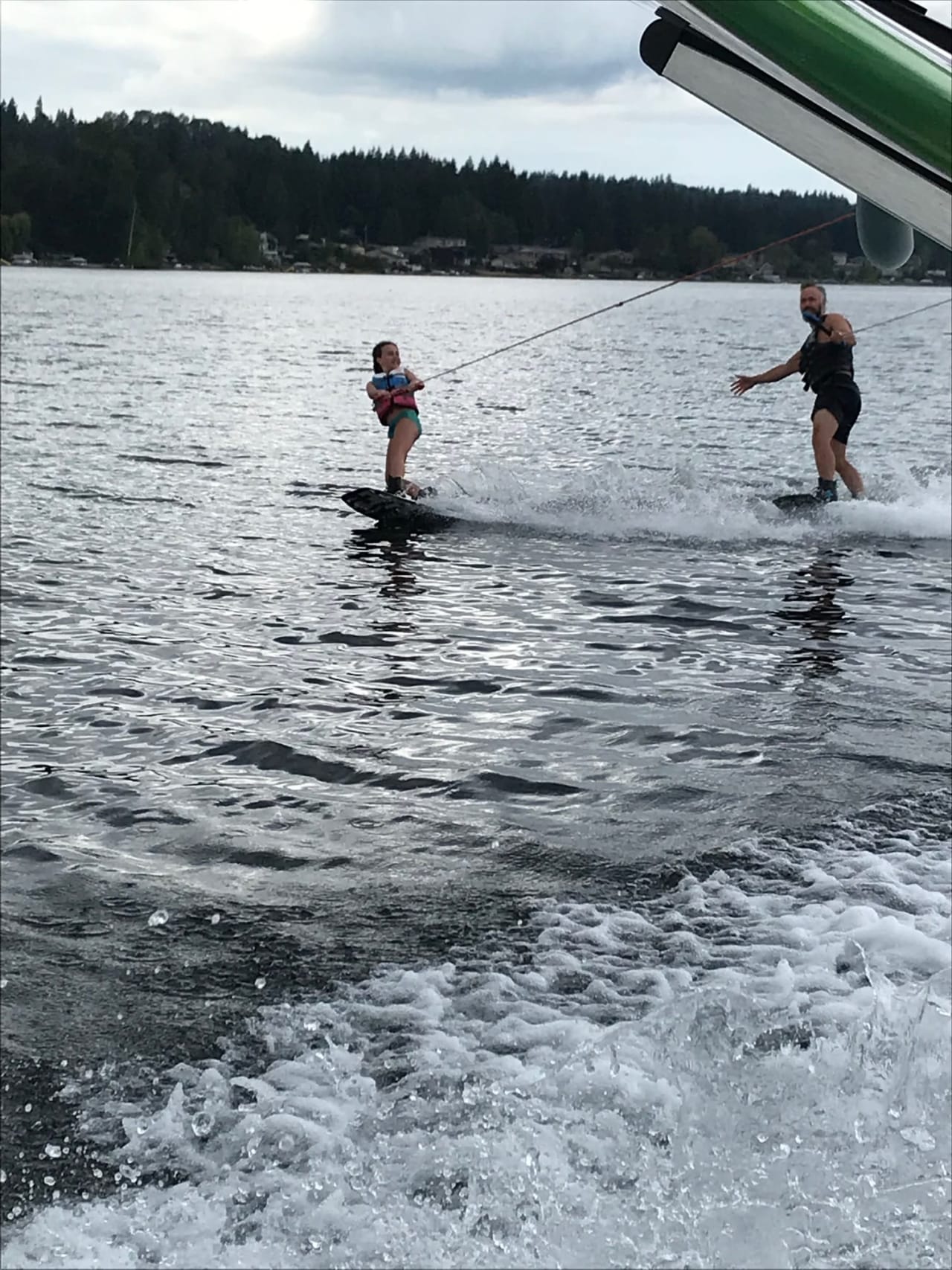 father and daughter enjoying wakeboarding in a lake