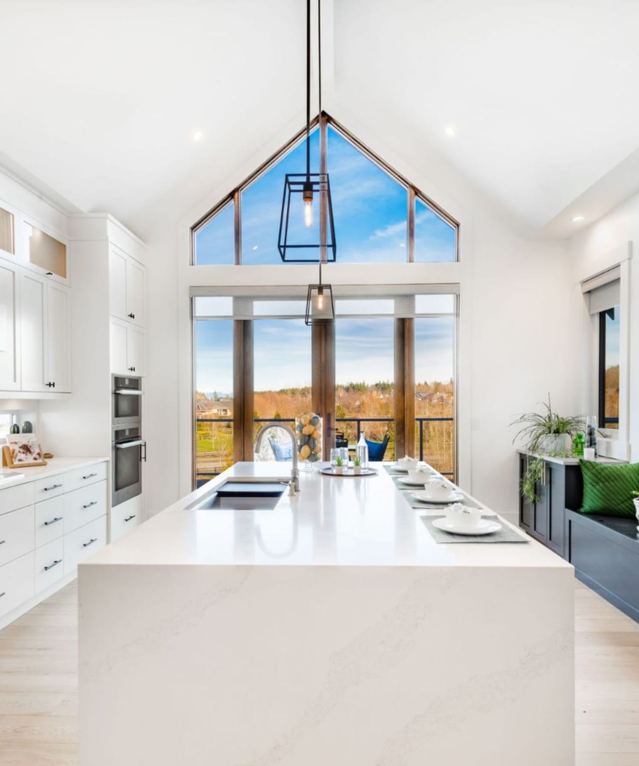 a kitchen with a large island in the center and lots of windows around it