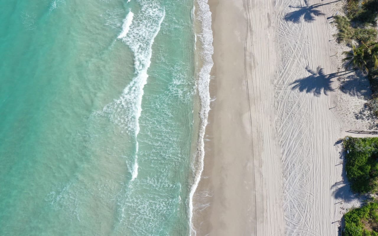 An aerial view of a beautiful beach with turquoise water.