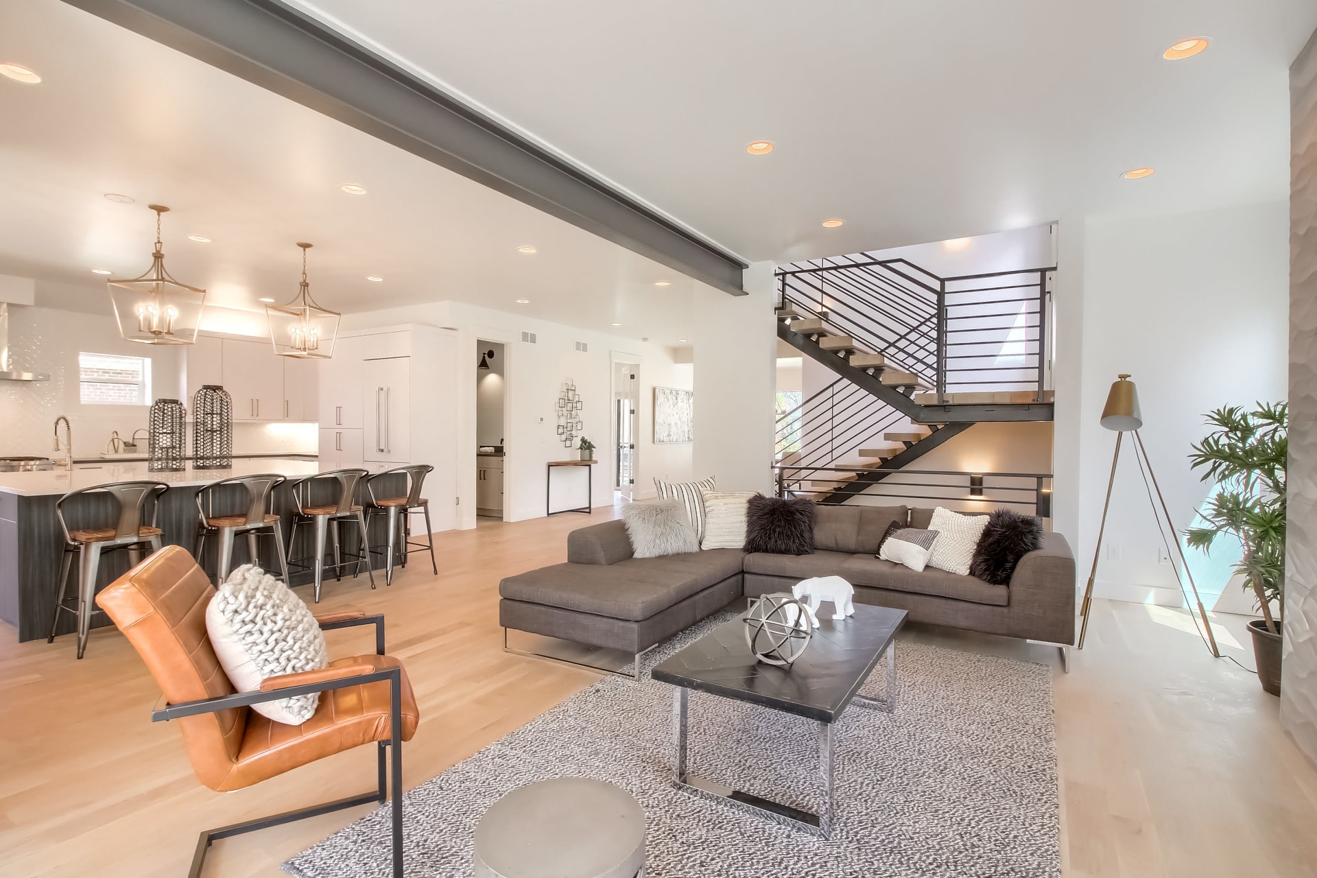  A spacious, open-concept living area and kitchen with a modern, industrial aesthetic.