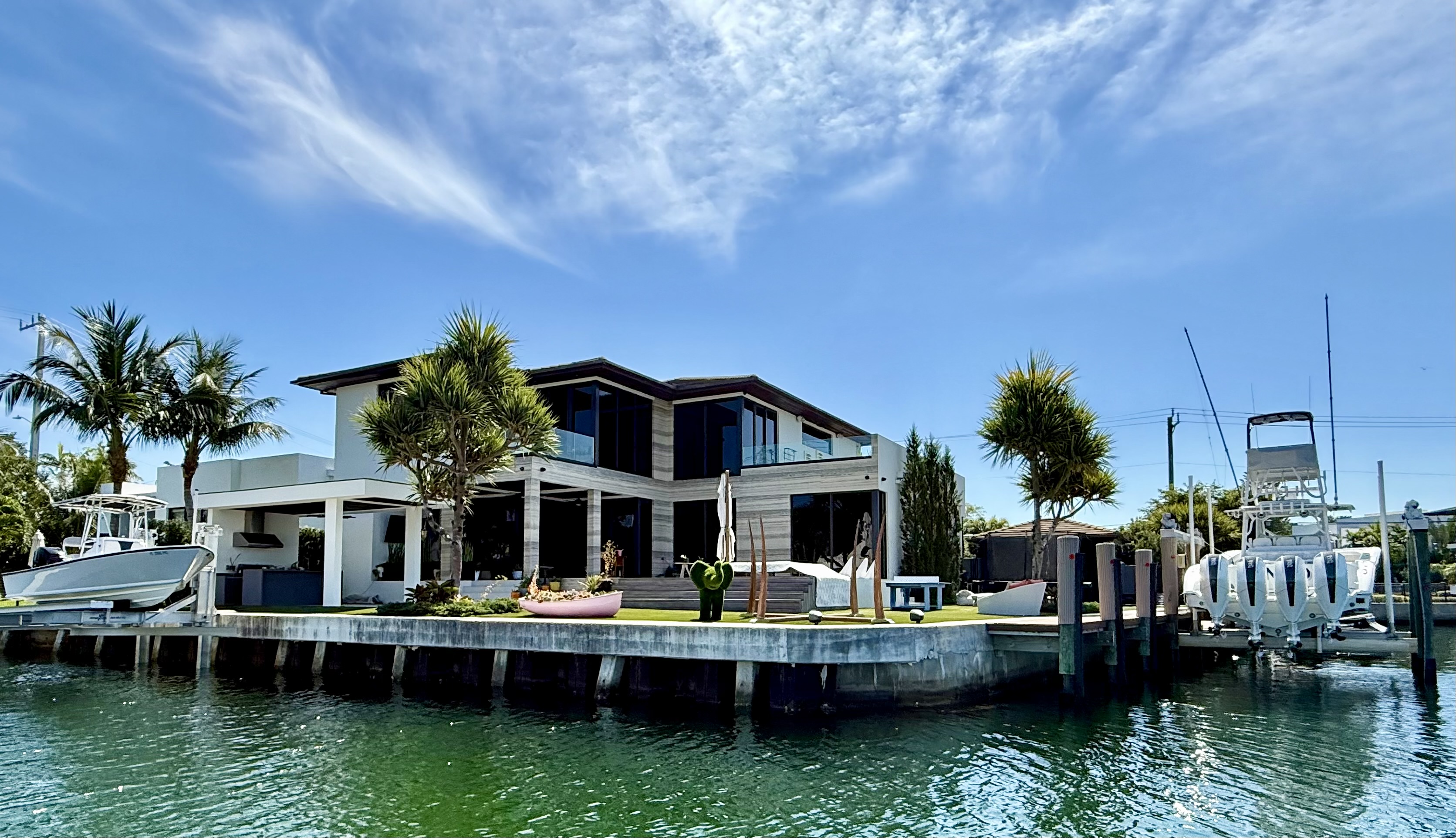 New modern luxury waterfront estate on a Keystone Point islands point lot featuring a new concrete seawall and extensive dock infrastructure for multiple vessels