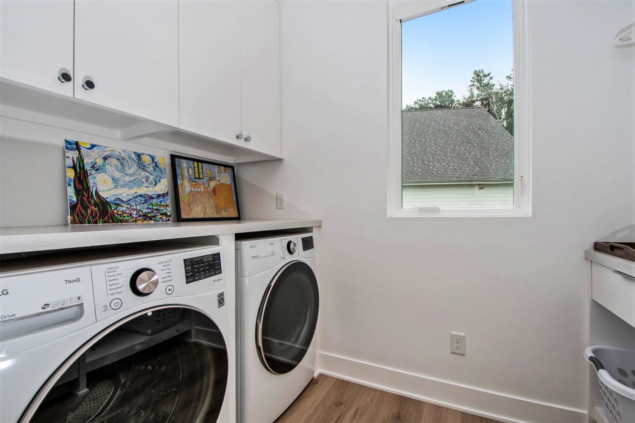 laundry room with two washing machine