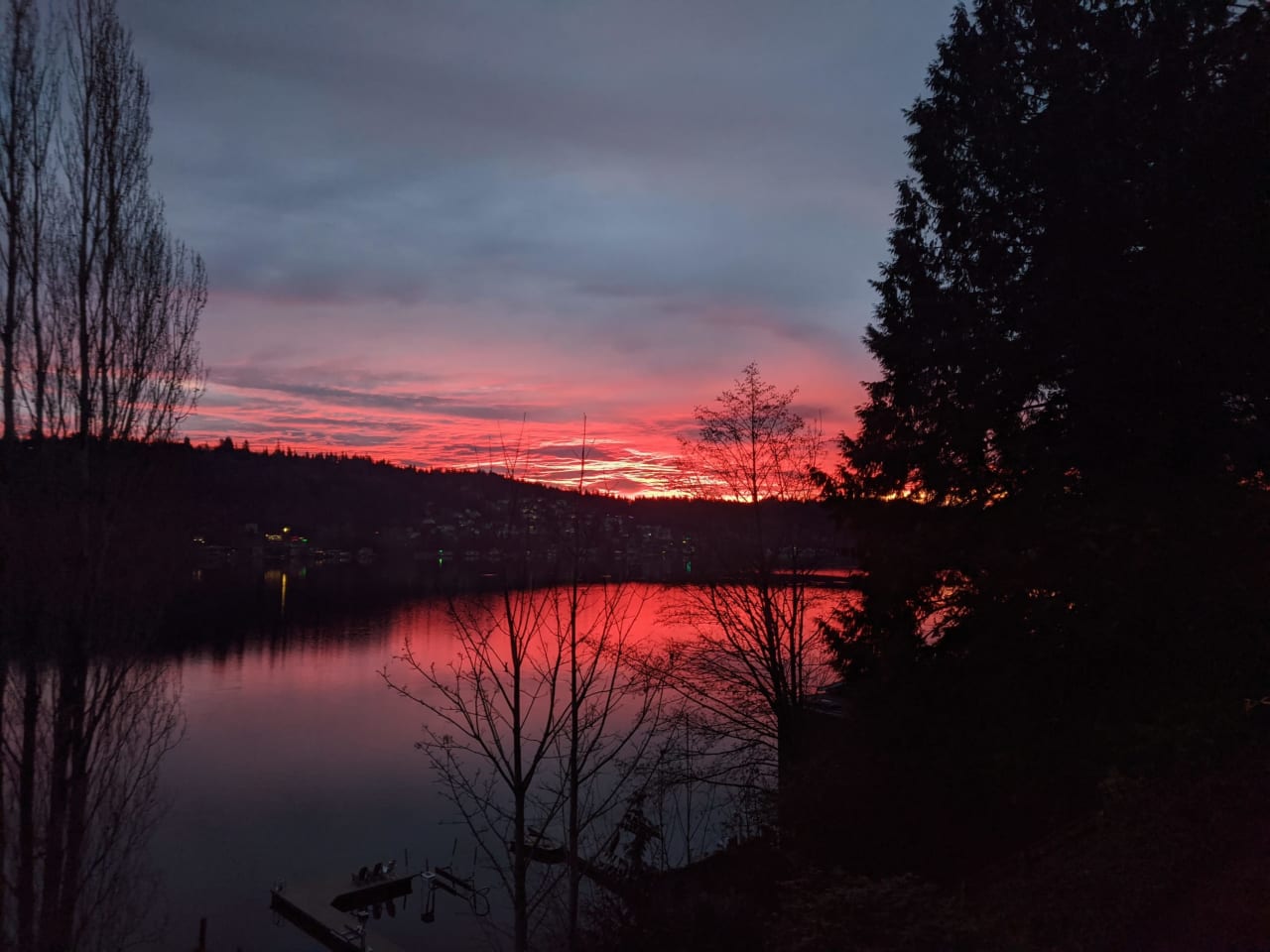 a red orange sunset over a lake