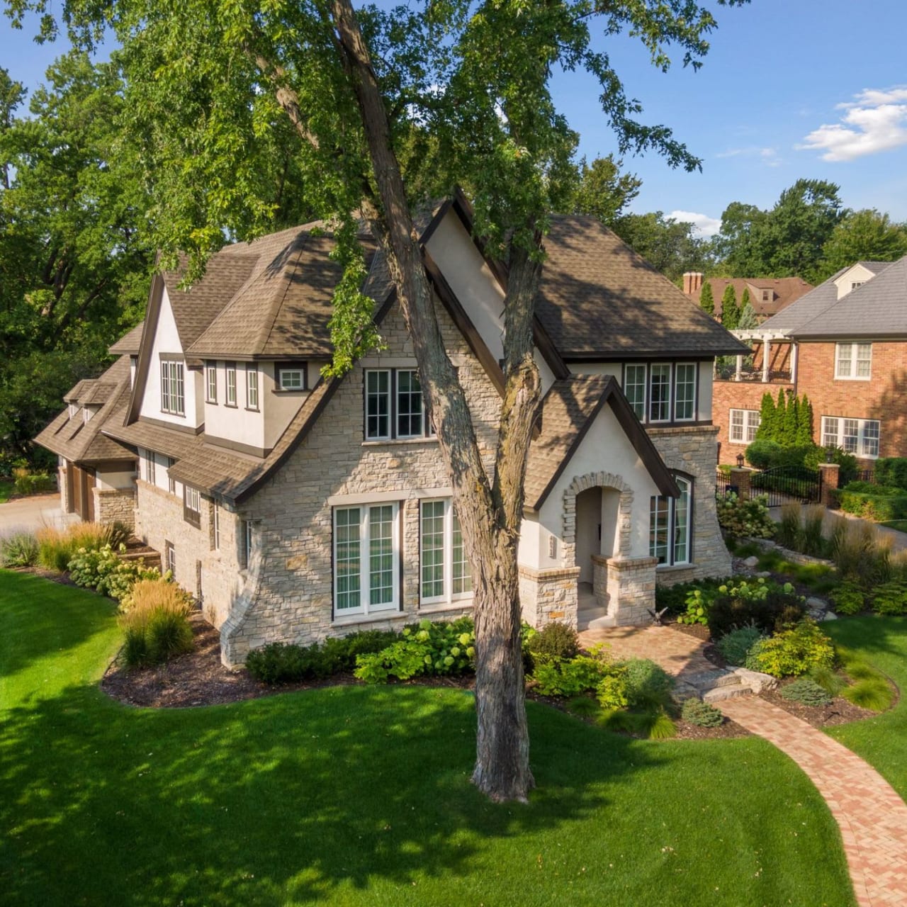 An aerial view of a large stone house with a tiled roof.