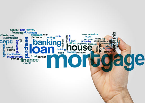 A person writing the word "mortgage" in a cloud filled with words related to mortgages.