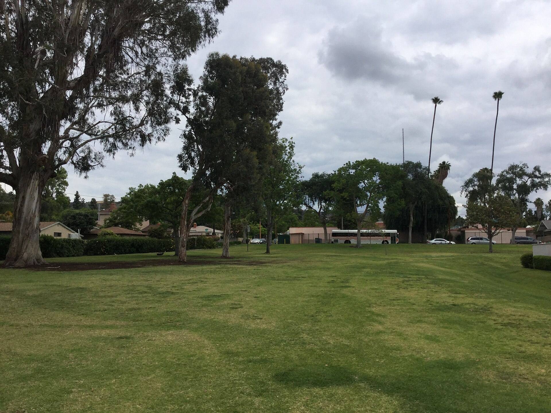 Lawn, mature trees and paths at Palm Park in Whittier