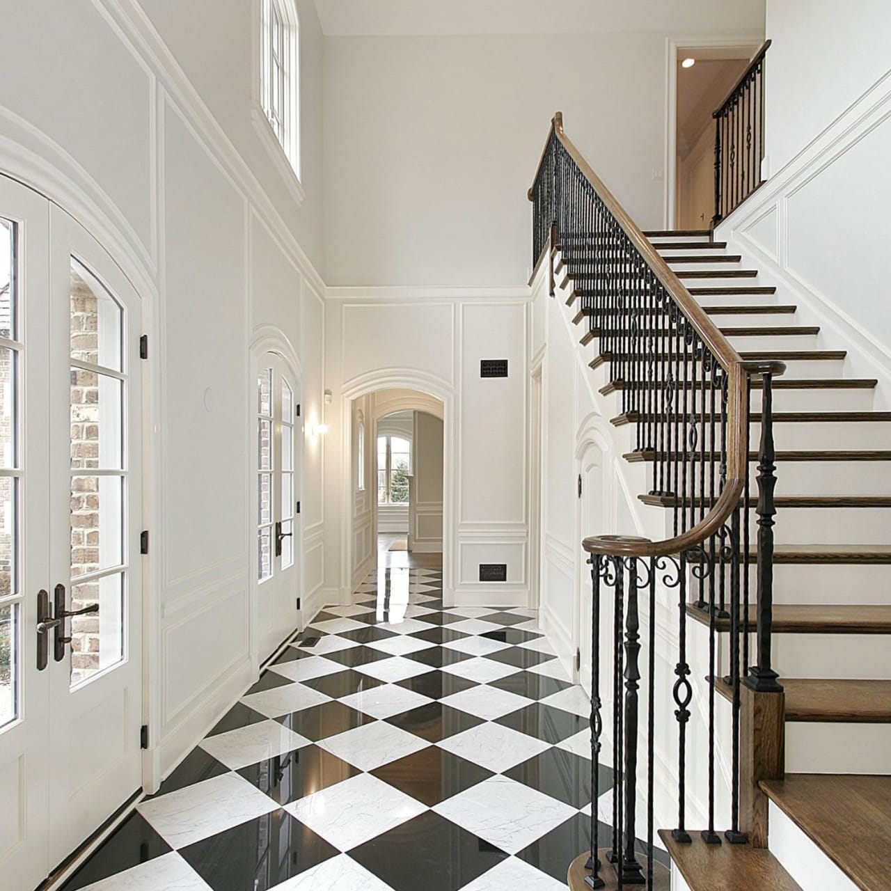 A long hallway with a black and white checkered floor. 