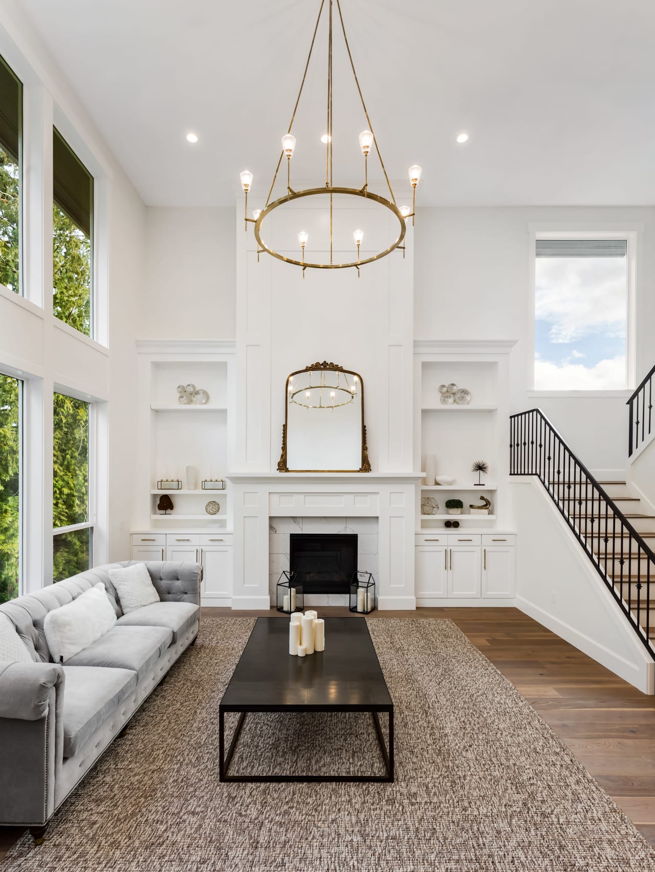 A living room with a plush couch, a fireplace with a stone mantel, and a coffee table in front.