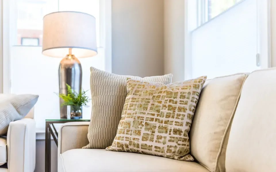 Cozy living room with couch and pillows in Spokane, WA.