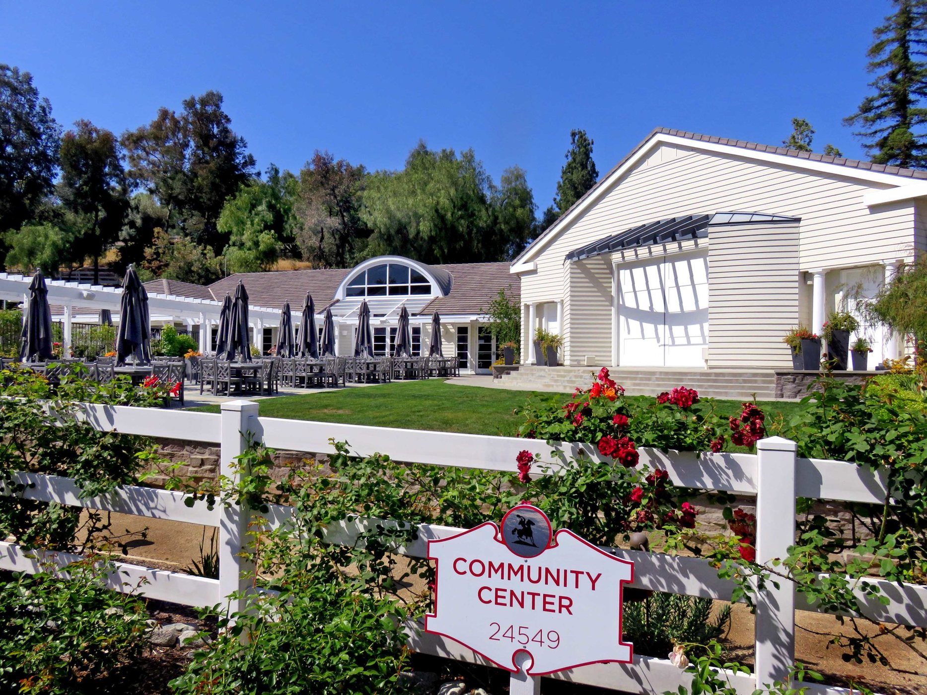 Hidden Hills Community Center with white fencing and landscaping, photographed June 2019