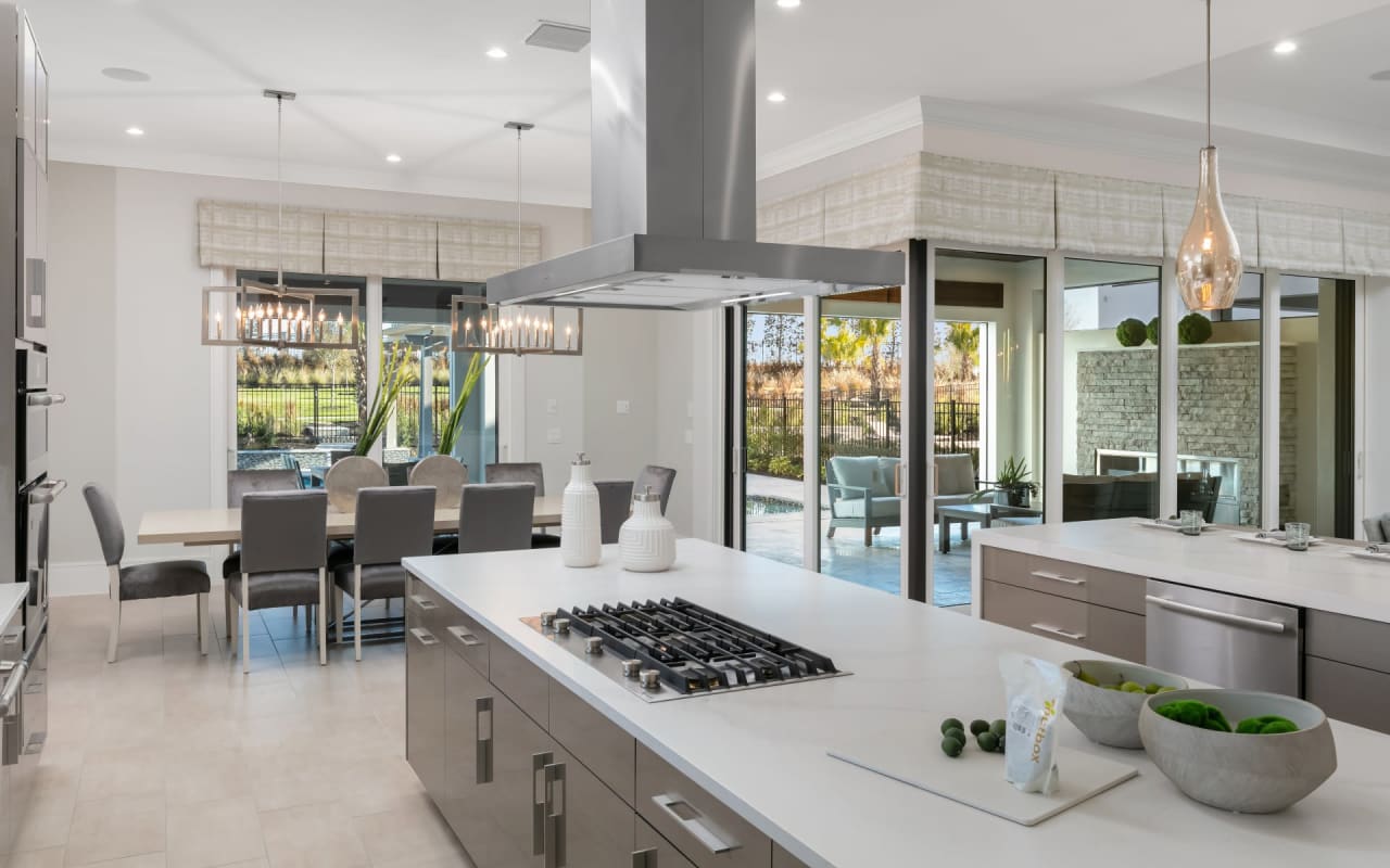 Beautiful kitchen island and dining area of a luxury home at The Bear's Den at Reunion Resort