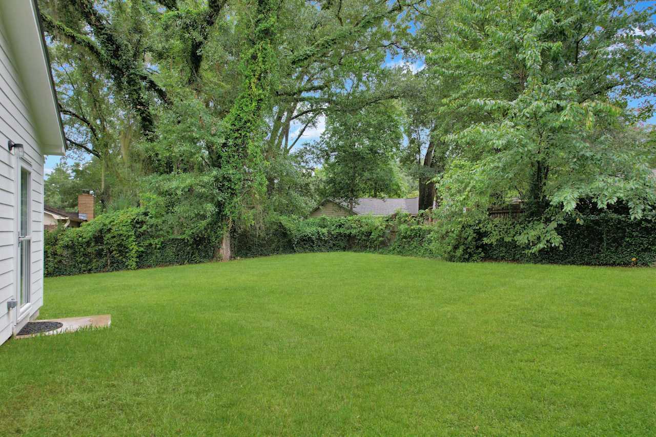 Photo of the backyard featuring fencing, lush green grass at 1228 Winifred Drive, Tallahassee, Florida 32308