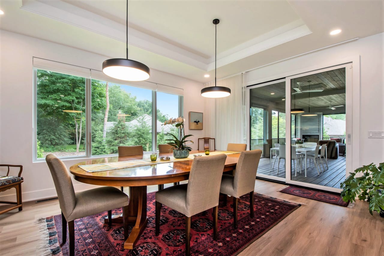 dining area with two pendant lightings with large windows