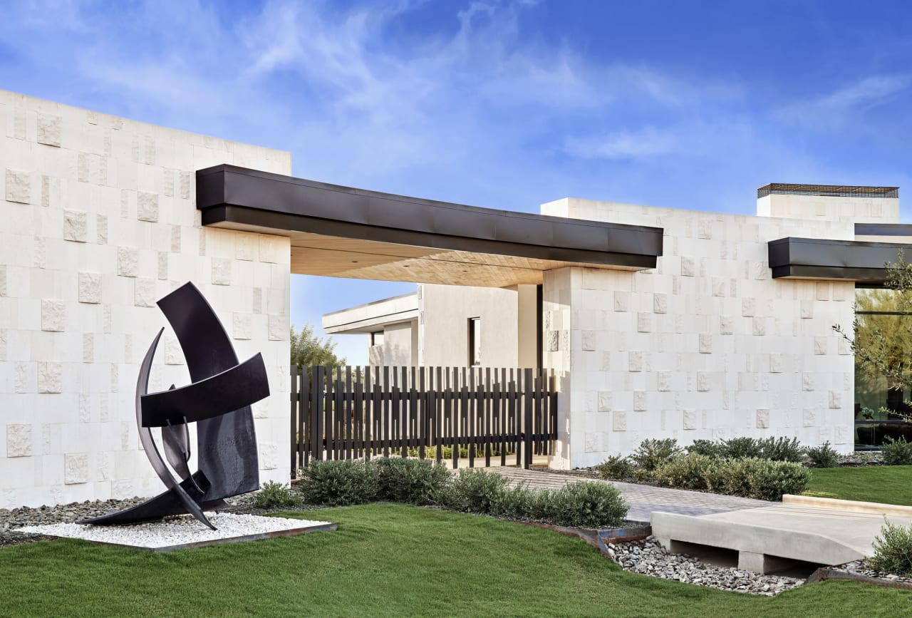 Radius shaped home with white stone and black accents