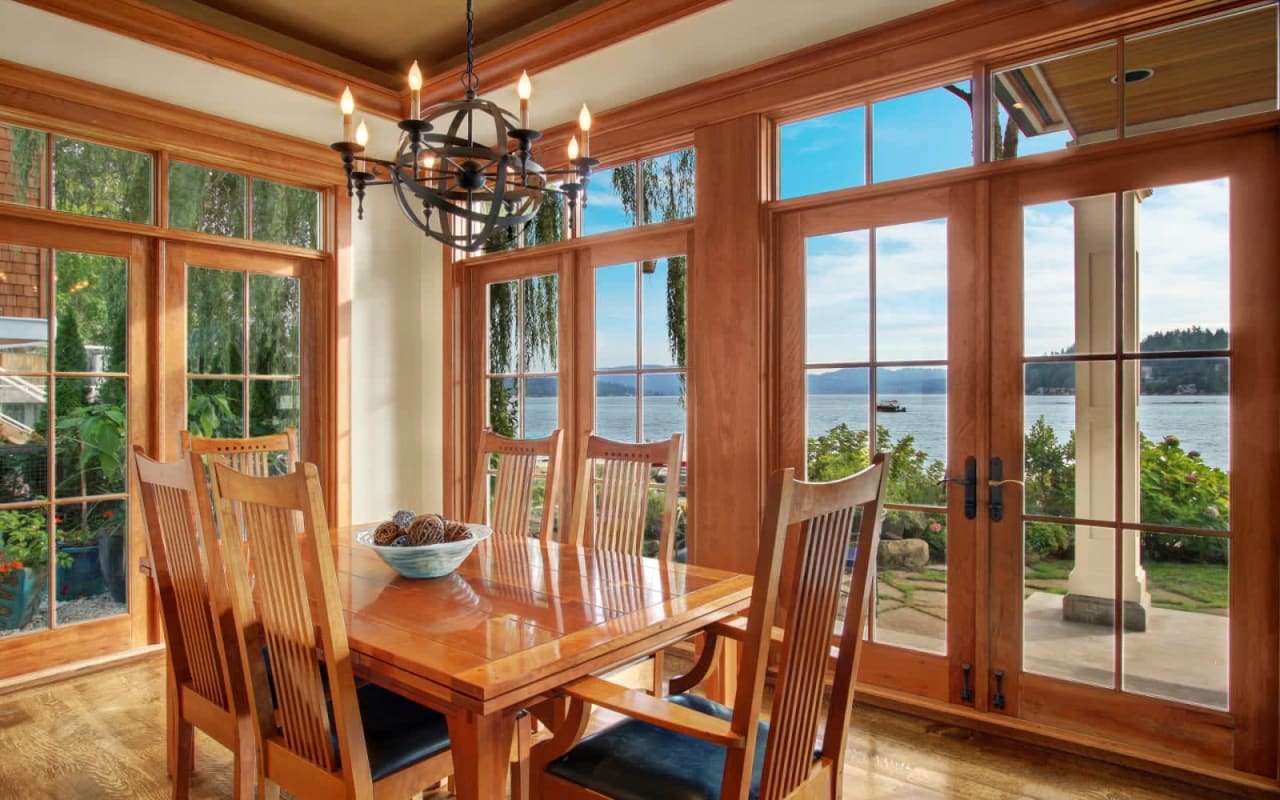 A well-lit dining room with a view of nature