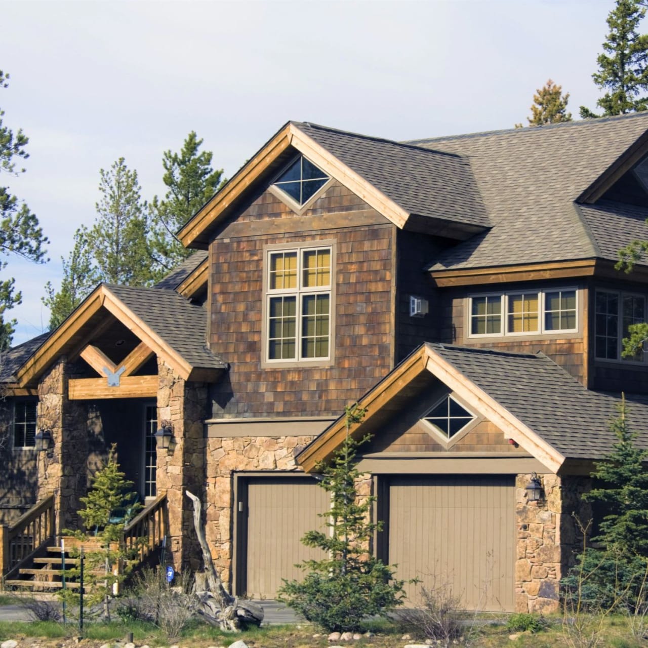 A large house with two garages in front of it.