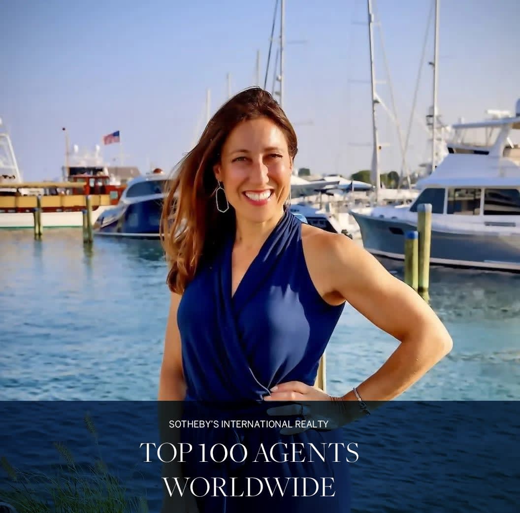 Bernadette Meyer smiling in front of boats at a harbor as Sotheby's International Realty Top 100 Agents Worldwide.