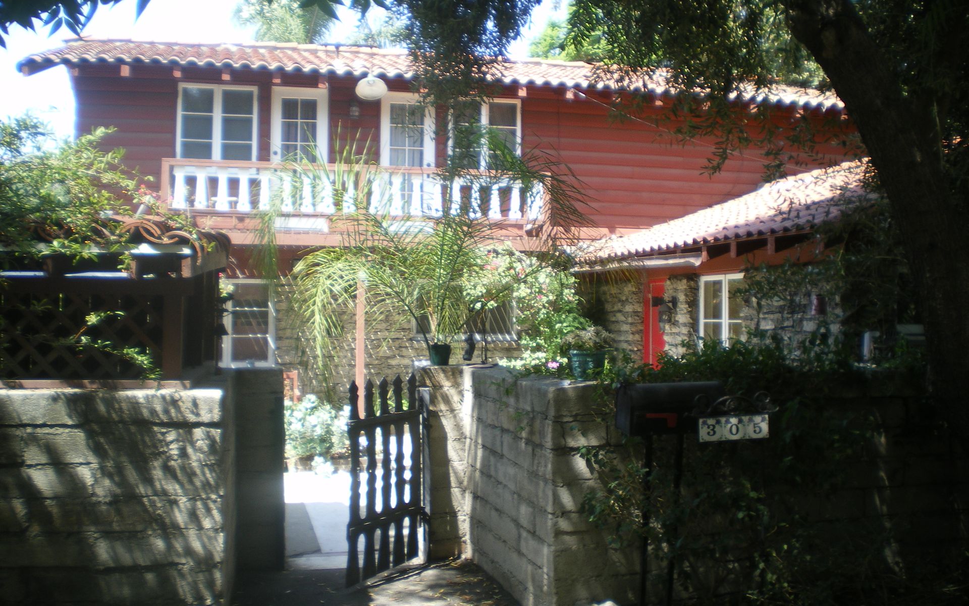 An established home behind trees in Claremont's Russian Village District